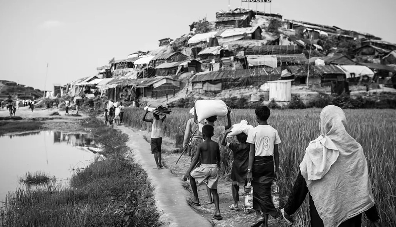 rohingya people walking nearby camp